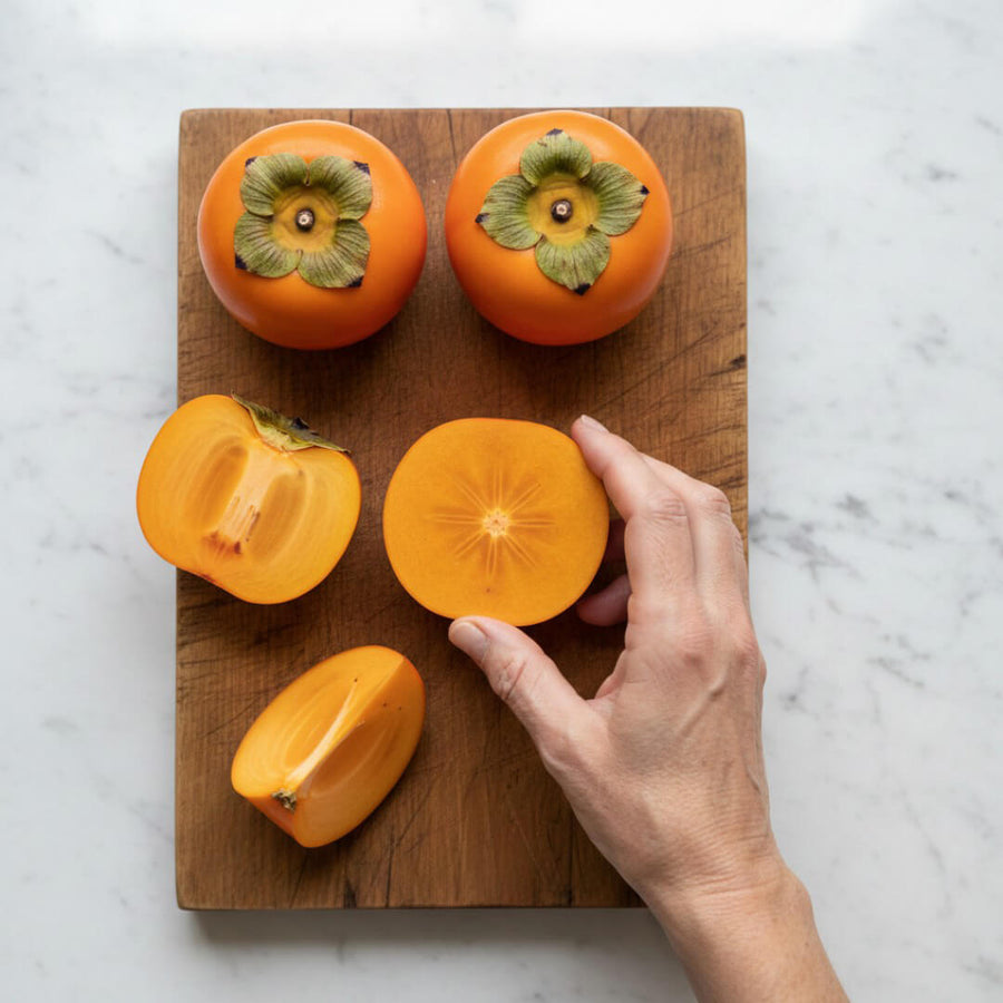 Fresh persimmons sliced on a cutting board